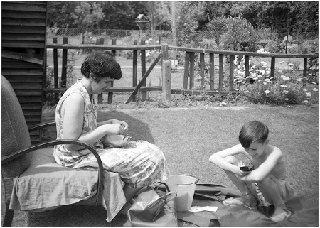 Hilda shelling peas & John texting on the world's first mobile.